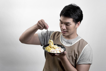 Asian man eatting spaghetti carbonara