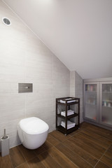 Bathroom with inclined wall