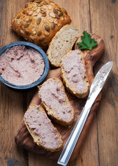 sandwiches with homemade chicken liver pate for breakfast on wooden cutting board