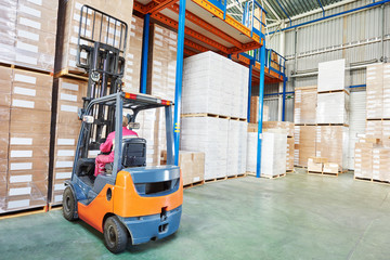 worker driver at warehouse forklift loader works