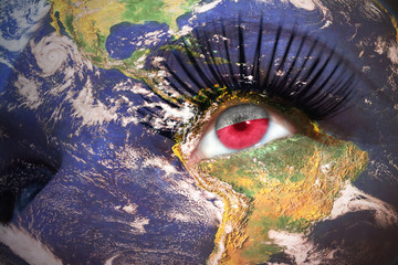 woman's face with planet Earth texture and polish flag inside the eye