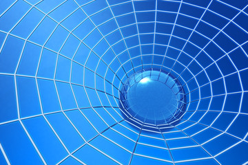 Network concept, clear drop of water in spider web on blue background