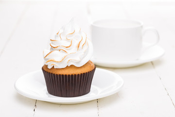 Fresh cake with white cream and a cup