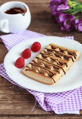 Belgium whole wheat waffles with raspberries and chocolate decor