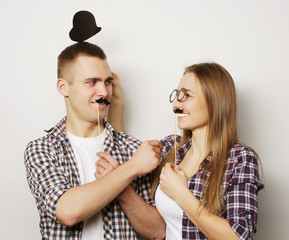 lovely happy couple hugging over grey background.