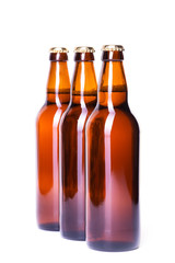 Three bottles of ice cold beer isolated on white
