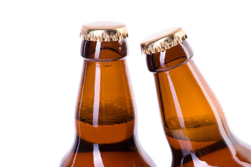 Two bottles of ice cold beer isolated on white