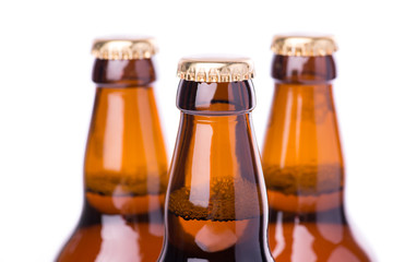 Three bottles of ice cold beer isolated on white