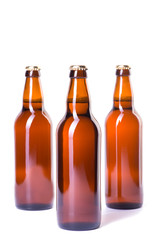 Three bottles of ice cold beer isolated on white