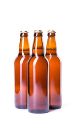Three bottles of ice cold beer isolated on white