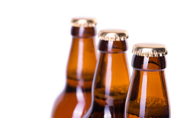 Three bottles of ice cold beer isolated on white