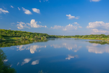 Fototapeta na wymiar Calm beautiful rural landscape with a lake 