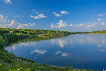 Naklejka na ściany i meble Calm beautiful rural landscape with a lake 