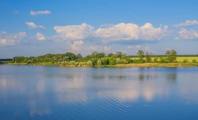 Calm beautiful rural landscape with a lake 