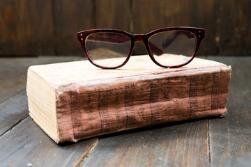 Vintage reading glasses on the book