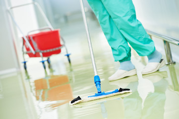 worker cleaning floor with machine