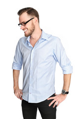 Man in his 20s standing wearing glasses and shirt looking away