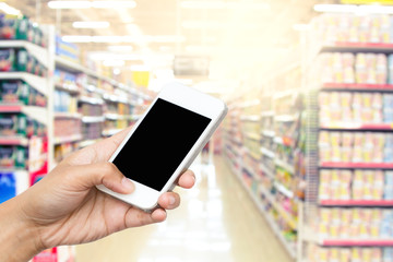 woman hand hold smart phone, tablet,cellphone on blur supermarke