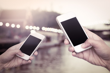 woman hand hold smart phone, tablet,cellphone on blurred lifesty