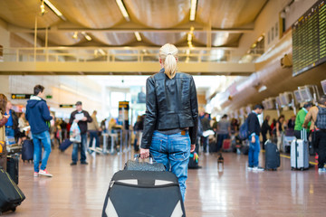 Female traveller walking airport terminal.