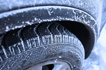 Wheel covered with hoarfrost concept of winter weather