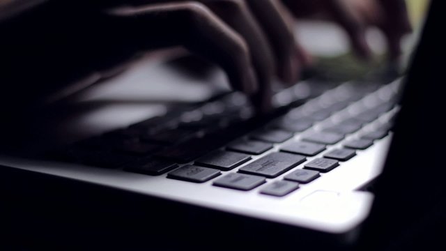 hands typing on computer or laptop keyboard