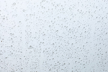 rain drop on the pink car glass in the rainy day 