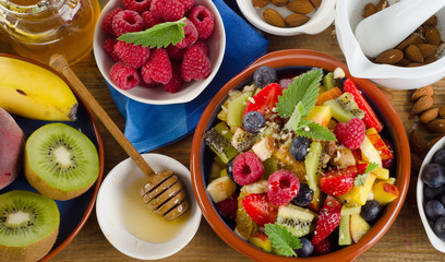 Healthy homemade fruit salad, fresh berries and fruits on  a  ru