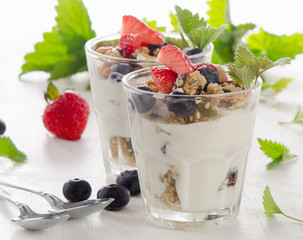 Granola with yogurt and fresh berries in  a glass.