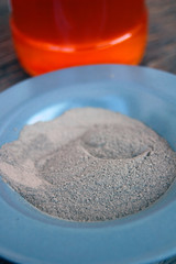 Cosmetic clay in a ceramic bowl with honey. Spa body and face treatment 