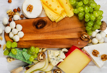 various types of cheese  on  wooden board .