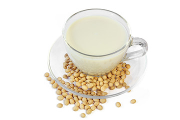 Soybeans and soy milk in a cup on white background
