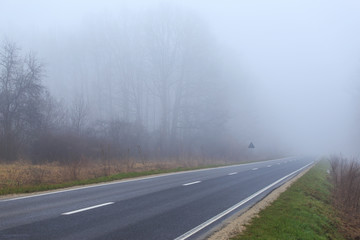 Mountain road in winter, on a overcast, foggy, day