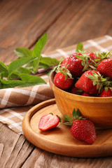 Strawberry close up in a wooden bowl