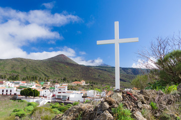 Summer mountain view with white wooden cross