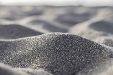 Volcanic black sand abstract and blurred closeup