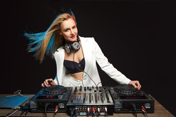 Beautiful blonde DJ girl on decks - the party,