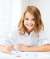 little girl painting at school