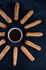 Fried churros with chocolate dip, mexican sun