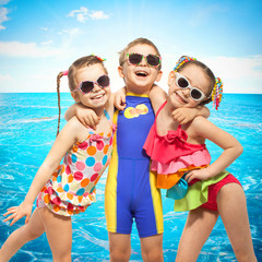 Happy kids in swimsuit at sea