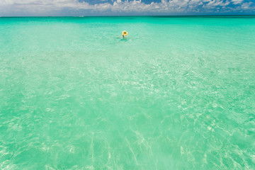 Fototapeta na wymiar Tourist swimming in clear waters of Bahamas