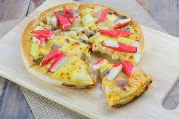 Homemade pizza on wooden table