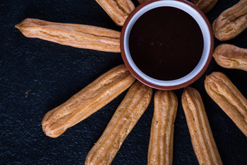 Fried churros with chocolate dip, mexican sun