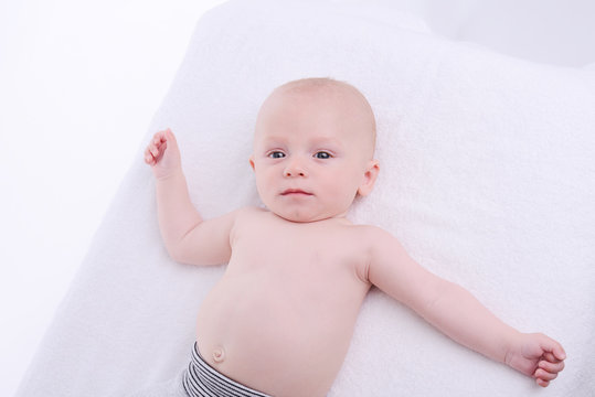 isolated portrait of young happy smiling baby on a white background