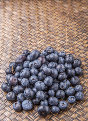 Blueberry fruits on wicker background