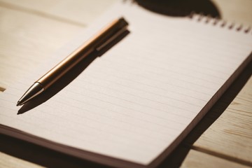 Empty notepad with pen