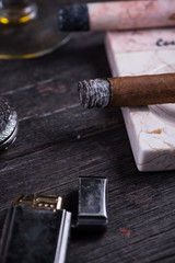 Cuban cigar in expensive marble ashtray