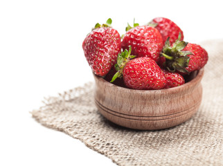 ripe strawberry in wooden bowl