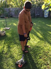 Boy using a weed wacker 
