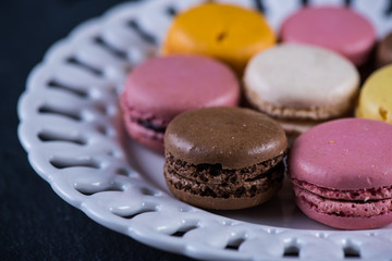 Colorful macaroons on serving plate